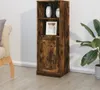 A tall, narrow wooden cabinet with a rustic finish, placed in a room next to a sofa and a plant. Voir les images du produit
