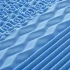 A close-up view of a blue foam mattress topper with different textured patterns. Anteprima dell’immagine prodotto