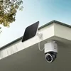 A solar-powered security camera mounted under the eaves of a house, with a tree branch visible in the background. Náhľad obrázku produktu