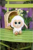 A plush sheep toy sits on a green chair with a basket and flowers in the background. Produktbild-Vorschau