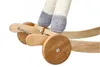 A close-up view of the wooden wheels and legs of a rocking horse. Podgląd zdjęcia produktu