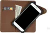 A brown leather wallet case for a smartphone, with a credit card and cash inside. Produktbild-Vorschau