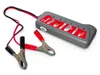 A car battery and alternator tester with red and black alligator clips is shown on a white background. Anteprima dell’immagine prodotto