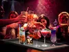 People toasting with cocktails at a bar. Produktbild-Vorschau