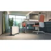 An office space with a desk, chair, computer, and a heater. Náhled obrázku produktu