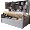 A grey wooden daybed with its storage compartment open, revealing bedding and pillows. The bed is part of a larger unit with shelves and cabinets above. Náhľad obrázku produktu