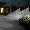 A house exterior at night with snow on the ground and lights illuminating the entrance. Produktbild-Vorschau