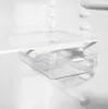 Close-up view of a transparent plastic drawer with white accents, mounted inside a white refrigerator. Produktbild-Vorschau