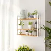A multi-tiered shelf unit with various potted plants and decorative items. Náhled obrázku produktu