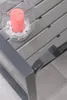 A close-up view of a garden bench with a candle in a glass holder. Produktbild-Vorschau