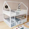 A white bunk bed with a house-like frame, set up in a room with light pink walls and a wooden floor. Voir les images du produit