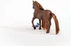 A brown toy horse standing on a white background with some small colorful toys near its feet. Voir les images du produit