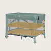 A teal travel crib with two tan platforms indicating different height levels. Náhľad obrázku produktu