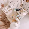 A child playing with a wooden toy workbench and tools. Produktbild-Vorschau