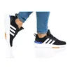 Two views of a person wearing Adidas shoes, shown from the side and slightly from the front. Podgląd zdjęcia produktu