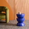 A modern living room setting with a green armchair, a blue side table with a mug, and a wood-paneled wall. Anteprima dell’immagine prodotto