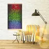 A living room scene with a colorful mosaic-style heating panel mounted on a white brick wall, next to a striped armchair and a floor lamp. Produktbild-Vorschau