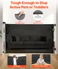 A baby gate is shown set up in a living room, with close-up insets highlighting its features and showing children interacting with it. Voir les images du produit