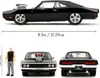 A black 1970 Dodge Charger R/T model car with a Dominic Toretto figure, shown from side, front, and rear views, with dimensions indicated. Náhľad obrázku produktu