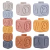 A collection of colorful, numbered silicone stacking blocks arranged in a grid. Voir les images du produit