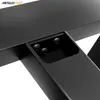 A close-up view of the connection point of black metal table legs, showing screws and a recessed area. Anteprima dell’immagine prodotto