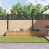 A backyard scene with a wooden planter box filled with plants, a fence, and a patio. Voir les images du produit