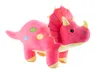 A pink plush triceratops dinosaur toy with colorful polka dots. Voir les images du produit