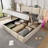 A bed with its storage compartment open, revealing stored items, in a bedroom setting. Voir les images du produit