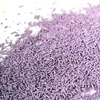 A pile of purple sprinkles on a white surface. Voir les images du produit