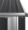 A close-up view of the corner of a dark grey metal shed roof and its silver trim. Náhľad obrázku produktu