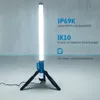 A tall, white LED work light on a tripod stand, with text overlays describing its features. Náhled obrázku produktu