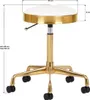 A white and gold rolling stool with measurement indicators. Produktbild-Vorschau