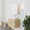A modern bathroom vanity with a sink, mirror, and cabinet, decorated with a plant and laundry basket. Podgląd zdjęcia produktu