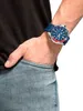 A man's arm wearing a watch, with his hand in his jeans pocket. Anteprima dell’immagine prodotto