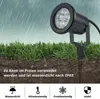 A black LED garden light with a stake is shown in the ground, with rain falling. Náhled obrázku produktu