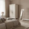 A bedroom scene with a bed, wardrobe, and mirror. Náhľad obrázku produktu