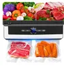 A vacuum sealer machine with food items in the background and sealed bags of food in the foreground. Podgląd zdjęcia produktu