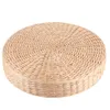 A round, thick seat cushion pouf made of woven natural material, presented on a white background. Voir les images du produit