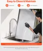 A person is cleaning a large stainless steel grill plate in a kitchen sink. Produktbild-Vorschau