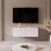 A modern living room with a wall-mounted TV and a white lowboard. Voir les images du produit