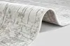 A close-up, folded view of a rug with a textured pattern. Produktbild-Vorschau