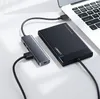 A USB hub and an external hard drive are connected to a laptop. Produktbild-Vorschau