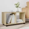 A wooden storage unit with books and a vase of flowers on top, placed next to a sofa. Náhled obrázku produktu