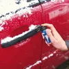 A hand is spraying a product onto a car door handle that is covered in snow. Produktbild-Vorschau