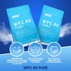 Two bags of protein powder are displayed against a blue background with white powder effects. Three circular icons with text below them highlight product features. Produktbild-Vorschau
