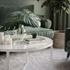 A modern living room scene with a coffee table, sofa, and plant. Produktbild-Vorschau