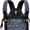 Close-up of the top part of a backpack, showing the straps and patterned fabric. Produktbild-Vorschau