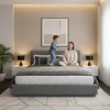 A mother and child are playing on a bed in a bedroom. Produktbild-Vorschau