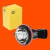 A product shot of a car headlight bulb and its packaging against an orange background. Produktbild-Vorschau