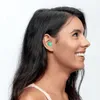 A woman wearing a green earplug in her ear. Voir les images du produit